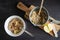 Top down view of preparation of oatmeal porridge with apple, cinnamon and raisins, bowl of oatmeal with spoon