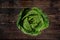 Top down view, savoy cole cabbage on dark wooden board