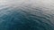 Top-down view of the sea waves. Sea ripples. Aerial view. The background of the sea. The texture of the water. Calm sea