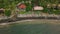 Top down view of seashore local village with villas, boats and palm trees.