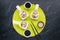 Top down view of small dishes of homemade deconstructed sushi on a bright green mat.