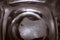 Top-down View of Square Bottom of Empty Beer Glass on Dark Table Surface. Bubbles Left from the Beer Head or Collar, Frothy Foam