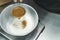 Top-down view of unrecognisable person sifting cocoa powder into bowl of flour to make chocolate cupcake batter