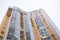 Top of facade of vivid modern gray-yellow residential building.