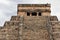 The top of the famous pyramid of Kukulkan against the sky, close-up