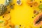 Top flat lay view photo of thirst-quenching fruit juice in glass jar kiwi, papaya, pineapple, orange on yellow background