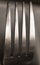 The top four prongs of a metal fork up close shining and reflect