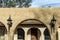 The top front view of a brown 1970's ranch style spanish style villa stucco cinder block home with architectural