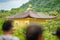 Top of golden pavilion with blurred tourist heads