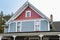 Top of a house with nice windows. Dormer in the blue sky background, Home Exterior. Real Estate Exterior Front House