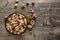 Top layout view transparent glass plate with different nuts on a wooden board