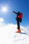 At the top: a lonely climber reaches the summit of a snowy mountain peak in winter season