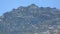 Top of mountain covered in rocks mixed with snow, skiing resort in summertime