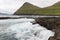 The top of the mountain of Faroe islands. A view of high peaks of mountains on a sunny day. Ocean view.  Beautiful panoramic view.