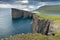 The top of the mountain of Faroe islands. A view of high peaks of mountains on a sunny day. Ocean view.  Beautiful panoramic view.
