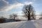 Top of the mountain and an old hut decorated with snow and sunshine.