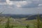 The top of the mountain in Zhangbei County looks at the grassland scenery under the blue sky and white clouds