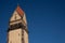 Top of a old building bell tower with clear bright blue sky -