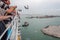 Top paddle of cruise ship with passengers observing seagulls and Venice harbor