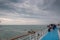 Top paddle of cruise ship with passengers observing seagulls and Venice lagoon