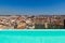 Top panoramic view of the Barcelona landscape from infinity swimmingpool. Europe, Barcelona, Spain. Historical buildings in the