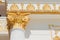 Top part of pillar, white column with golden top, exnterior detail
