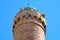 The top, the roof of the minaret with the symbol of the crescent moon and the speakers through which the muezzin singer