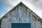 Top roof of old weathered wooden barn against dramatic sky