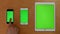 Top shot of hand touch phones and ipad on green screen