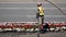 Top shot of traffic flow with worker pouring water on flowers