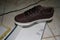 Top and side view of sports shoes brown color, withe color shoes on box cover