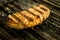 A top sirloin steak flame broiled on a barbecue shallow depth of field.