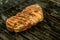 A top sirloin steak flame broiled on a barbecue shallow depth of field.