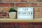 Top Stories word in light box on brick wall and wooden shelves background