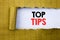 Top Tips. Business concept for Expert Tip Guidance written on white paper on the yellow folded paper.