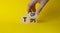 Top Tips symbol. Businessman hand Turnes cubes with words Top Tips. Beautiful yellow background. Business and Top Tips concept.