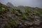 The top of Ulriken mountain near the town of Bergen, Norway with a cabin in the foggy landscape