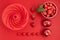 Top veiw of fresh and juicy sunmmer fruits and kitchen utensils on red background. Summertime, red fruits, vitamins, cooking,