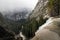 Top of Vernal Falls in Yosemite National Park as mist rolls over the mountain tops