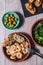 Top vertical view of a wooden table with different tapas dishes