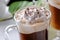 Top of  Viennese coffee glass topped with whipped cream and chocolate chips close-up