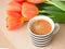From top vies blackcoffee with orange tulips concetp for morning coffee from top views