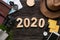 Top view 2020 happy new year number on wood table with adventure accessory item,holiday vacation planning