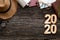 Top view 2020 happy new year number on wood table with adventure accessory item,holiday vacation planning