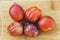 Top View of 5 Amigo Pluot Fruits on a Wood Chopping Board