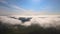 Top view from above of landscape covered with puffy morning fog. Cold humid air condensing in rain clouds