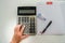 Top view accountant with calculator, pen and correction fluid for tax and company income calculation