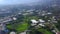 Top view of agricultural fields with green plants in city. Clip. Plots of agricultural fields with greenhouses growing