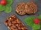 top view of almond bar and granola cookies with fruits, strawberry and raspberry with leaf