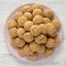 Top view, almond cookies on pink plate on a white wooden table. Flat lay, overhead, from above